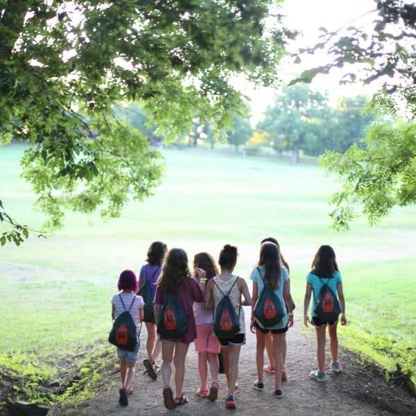 Group of Treehouse Village girls walking up the hill at the best Christian youth camp Shepherd's Fold Ranch.