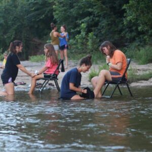 Christian Campgrounds SFR has Ranch Campers have a foot washing event by the creek