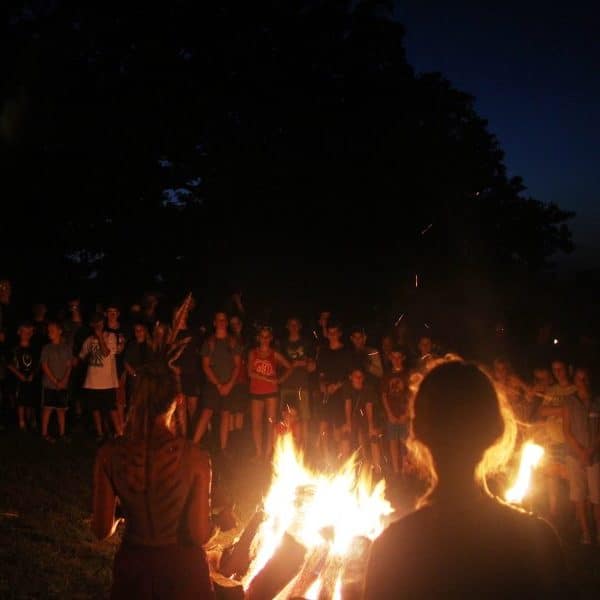 Campfire gathering with crowd at night