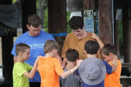 Group of boys praying outdoors together