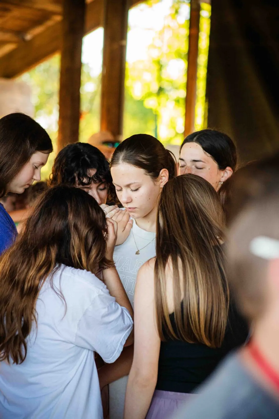 Group of teenagers huddled closely together