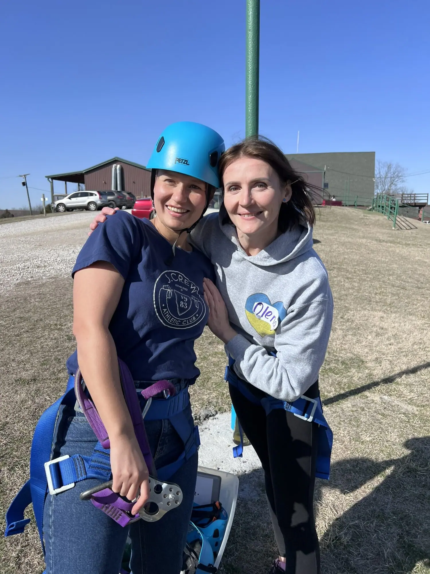 Two women posing outdoors with climbing gear.
