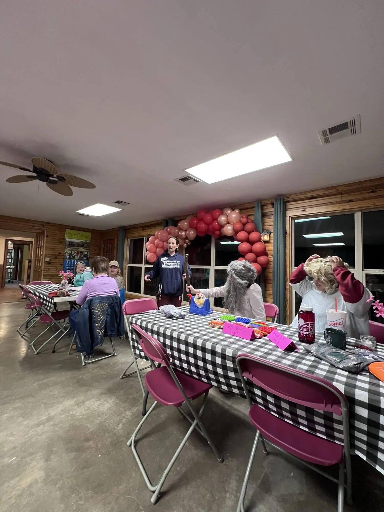 Shepherd's Fold Ranch - Christian Summer Camp - People sitting at tables with colorful balloons.